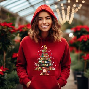 May include: Red hooded sweatshirt with a Christmas tree design made of books. The tree is decorated with ornaments, a star, and snowflakes. A Santa Claus figure is at the base of the tree.